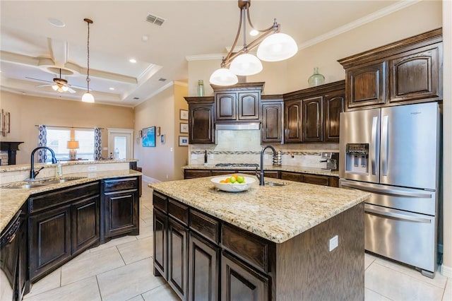 kitchen with backsplash, ornamental molding, stainless steel refrigerator with ice dispenser, and a sink