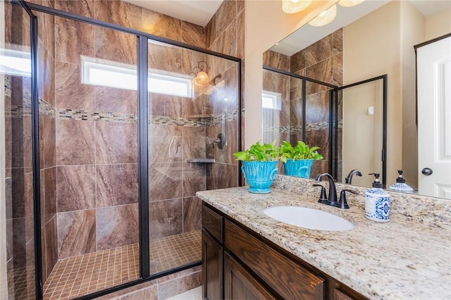 full bath with a stall shower and vanity