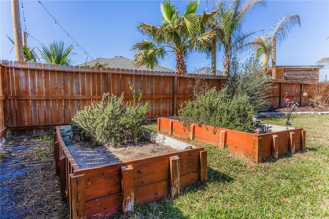 view of yard featuring fence private yard and a vegetable garden