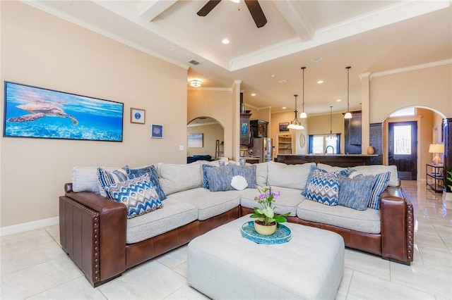 living room with arched walkways, beam ceiling, and crown molding