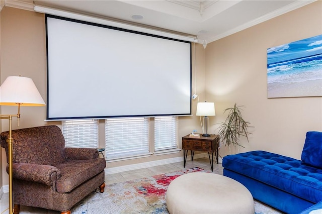 living area with baseboards and crown molding