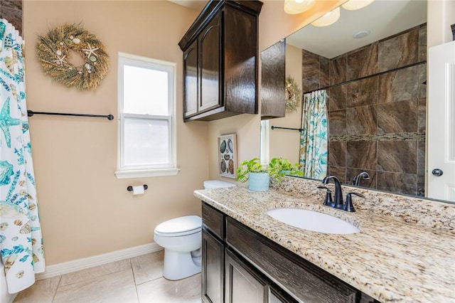 bathroom featuring baseboards, a shower with shower curtain, toilet, tile patterned flooring, and vanity