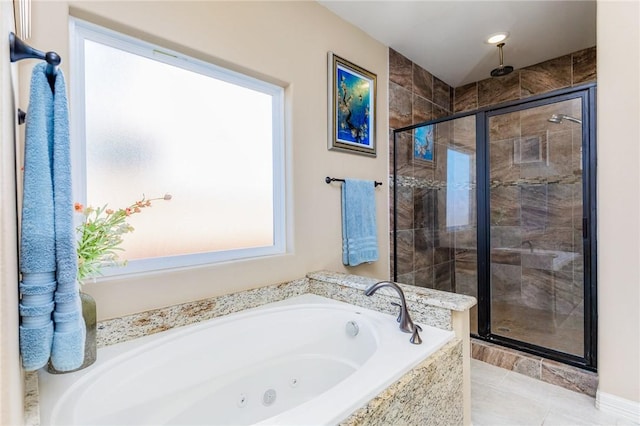 full bathroom with a tub with jets, a stall shower, and tile patterned floors