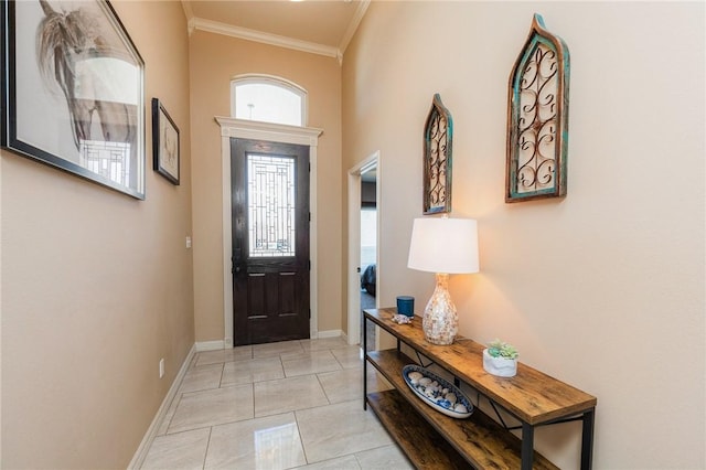 foyer entrance featuring light tile patterned floors, baseboards, and crown molding