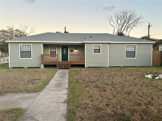 view of front facade with a porch and a yard