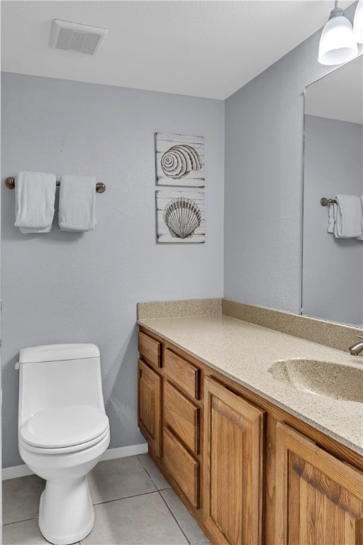 bathroom featuring toilet, vanity, and tile patterned floors