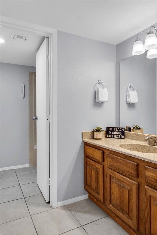 bathroom with vanity, tile patterned floors, and a shower