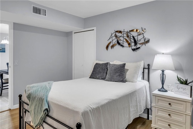 5973 State Highway 361 Unit 203, Port Aransas, TX 78373 - bedroom featuring wood finished floors, a closet, and baseboards