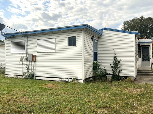 view of side of home featuring a lawn