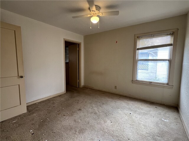 unfurnished bedroom with ceiling fan and carpet