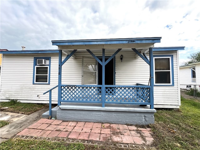 back of property featuring covered porch