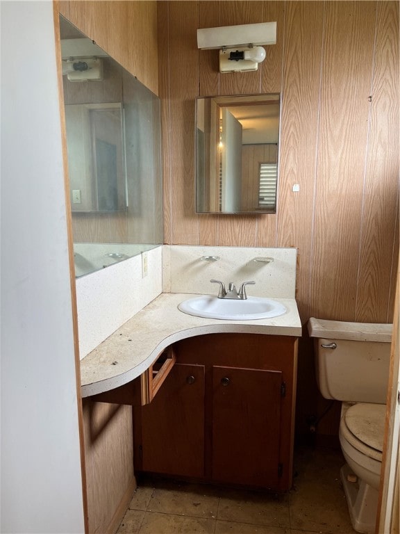 bathroom featuring vanity, toilet, and tile patterned floors