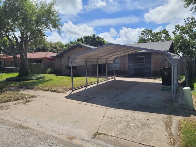 2021 Melisa Ln, Corpus Christi, TX 78412 - view of parking with driveway and a carport