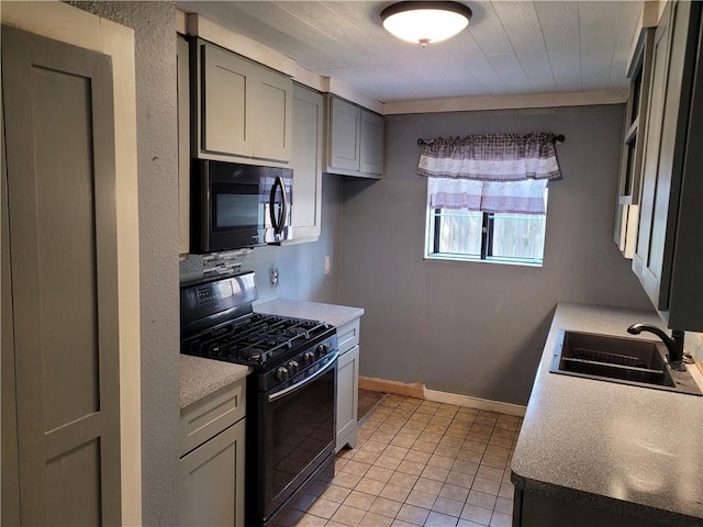 2021 Melisa Ln, Corpus Christi, TX 78412 - kitchen with black appliances, light tile patterned floors, gray cabinetry, and light countertops