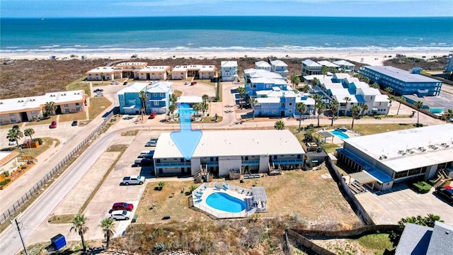 drone / aerial view with a water view and a beach view