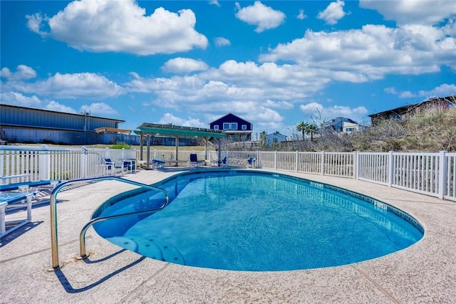 pool featuring a patio area and fence