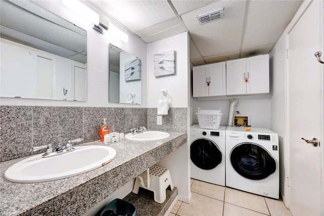 laundry area featuring laundry area, visible vents, a sink, and washing machine and clothes dryer