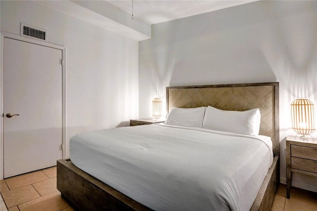 bedroom featuring light tile patterned floors and visible vents