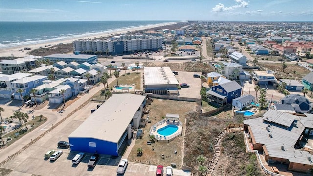 bird's eye view with a water view and a beach view