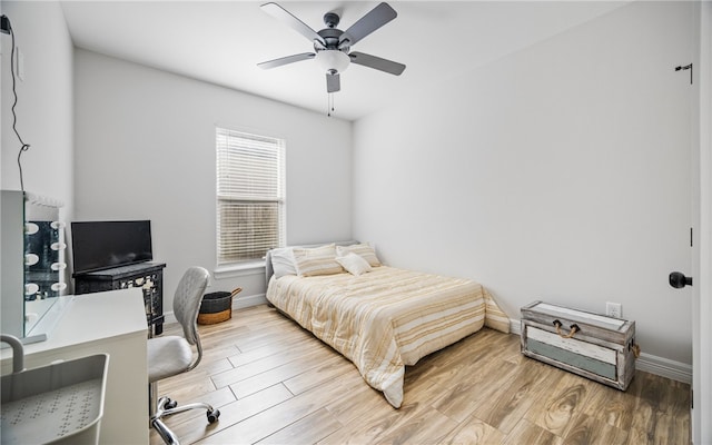 bedroom with wood-type flooring and ceiling fan