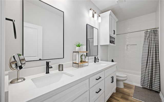 full bathroom featuring vanity, hardwood / wood-style floors, toilet, and shower / bath combo with shower curtain