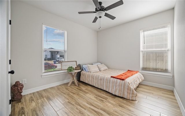 bedroom with ceiling fan and light wood-type flooring