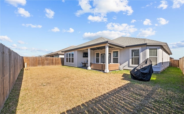 rear view of house with a yard, an outdoor hangout area, and ceiling fan