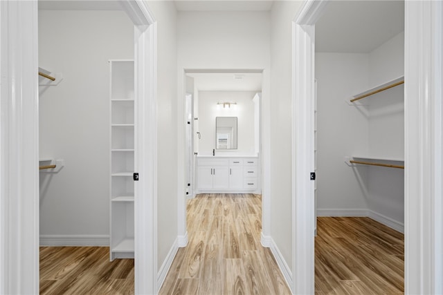 spacious closet featuring light wood-type flooring