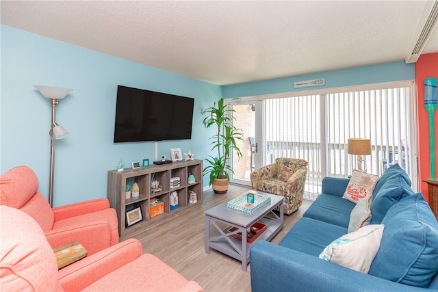 14810 Windward Dr Unit 203, Corpus Christi, TX 78418 - living room with wood finished floors and a textured ceiling
