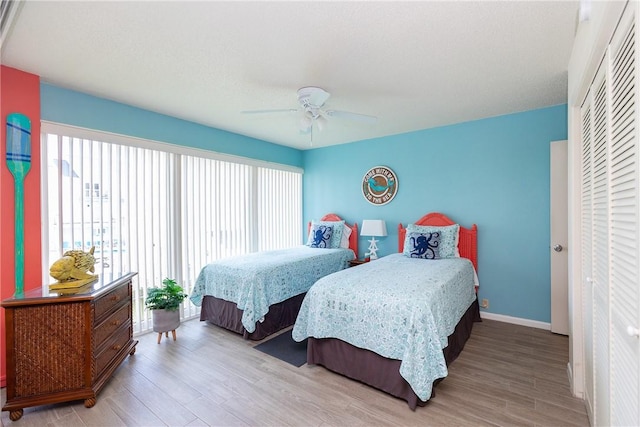 14810 Windward Dr Unit 203, Corpus Christi, TX 78418 - bedroom with multiple windows, wood finished floors, and ceiling fan