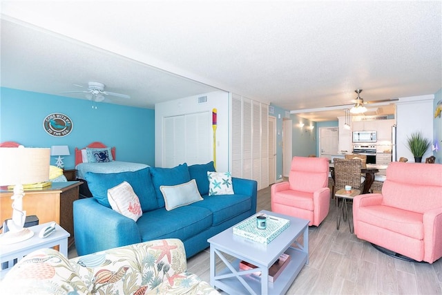 14810 Windward Dr Unit 203, Corpus Christi, TX 78418 - living room with ceiling fan and light wood finished floors