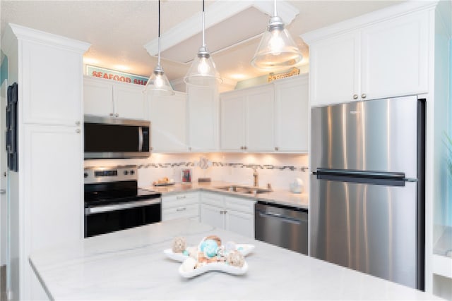 14810 Windward Dr Unit 203, Corpus Christi, TX 78418 - kitchen with appliances with stainless steel finishes, decorative backsplash, and white cabinetry