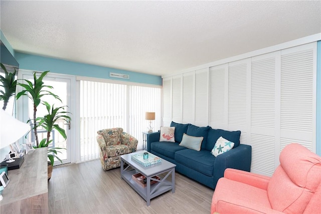 14810 Windward Dr Unit 203, Corpus Christi, TX 78418 - living area featuring light wood finished floors and a textured ceiling