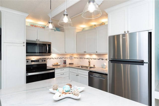 14810 Windward Dr Unit 203, Corpus Christi, TX 78418 - kitchen featuring stainless steel appliances, tasteful backsplash, white cabinetry, decorative light fixtures, and a textured ceiling
