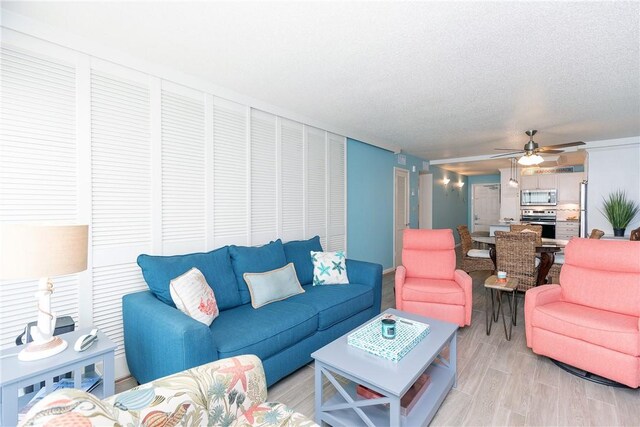 14810 Windward Dr Unit 203, Corpus Christi, TX 78418 - living room with a ceiling fan and light wood-style flooring