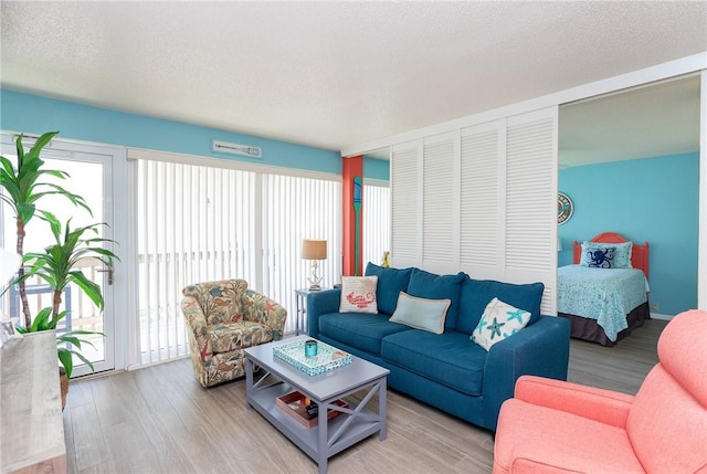14810 Windward Dr Unit 203, Corpus Christi, TX 78418 - living area featuring wood finished floors and a textured ceiling
