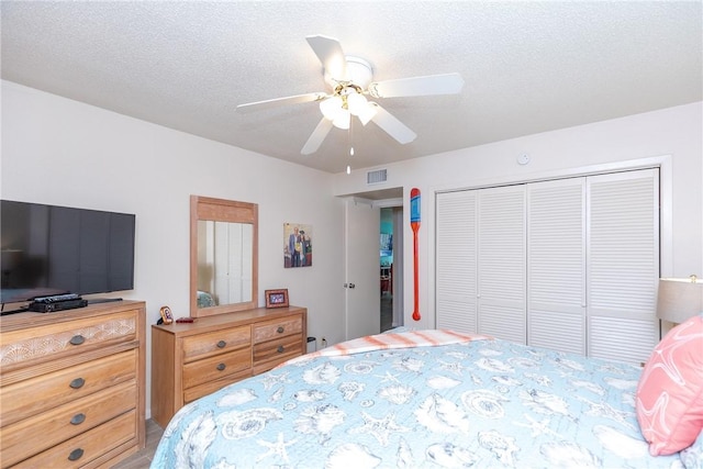 14810 Windward Dr Unit 203, Corpus Christi, TX 78418 - bedroom with a closet, ceiling fan, and a textured ceiling