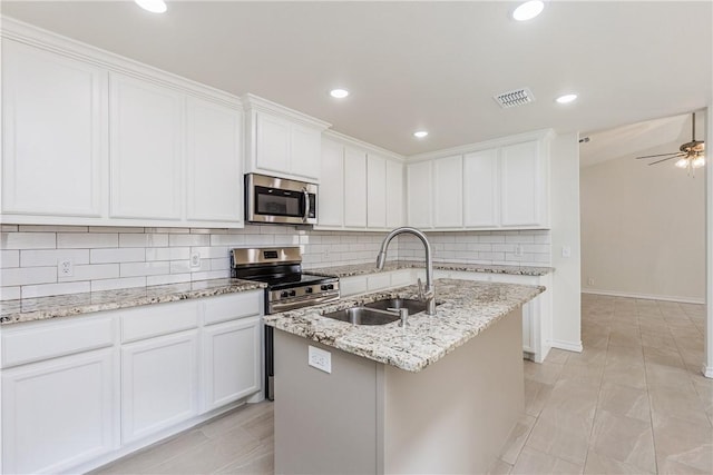 2325 Roseland Dr, Corpus Christi, TX 78414 - kitchen featuring a sink, stainless steel appliances, tasteful backsplash, visible vents, and white cabinets