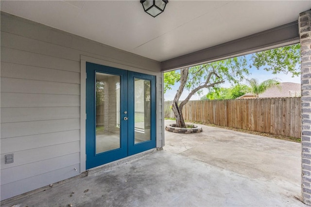 2325 Roseland Dr, Corpus Christi, TX 78414 - view of exterior entry with fence, a patio area, and french doors