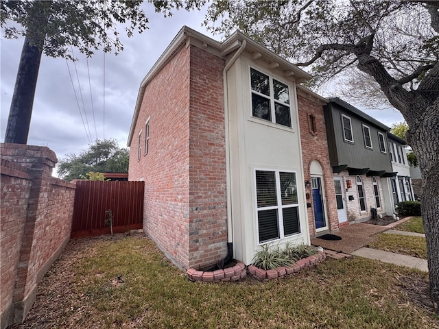 view of side of home featuring a lawn