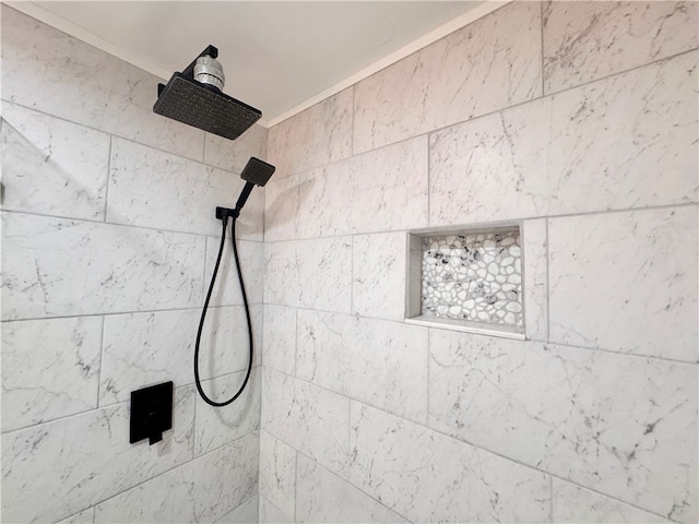 room details with a tile shower and ornamental molding