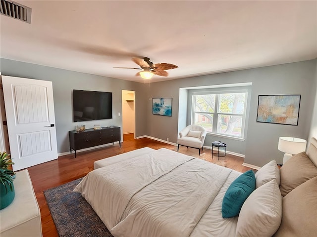 bedroom with wood-type flooring and ceiling fan