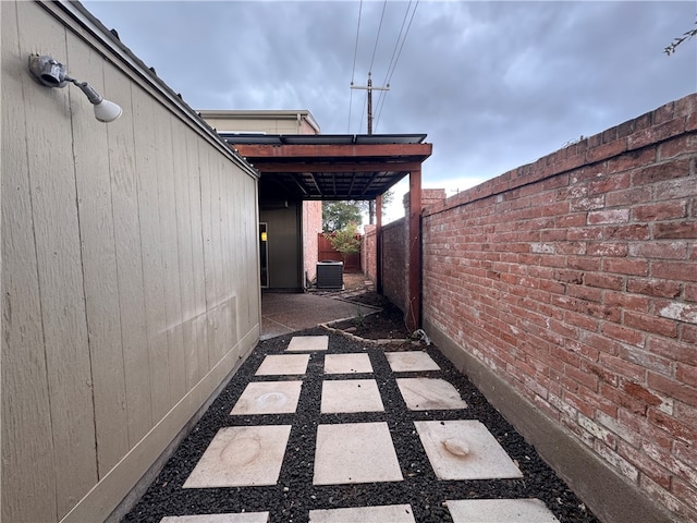 view of home's exterior featuring central AC and a patio