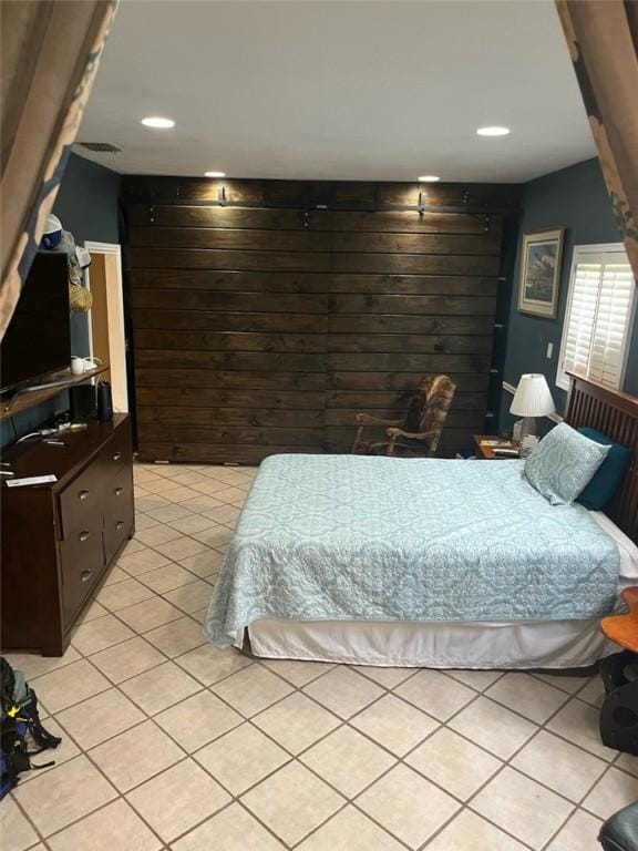 66 Redfish Dr, Rockport, TX 78382 - bedroom featuring light tile patterned floors, wood walls, and recessed lighting