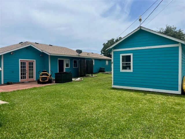 66 Redfish Dr, Rockport, TX 78382 - back of property with french doors, a yard, and a patio area