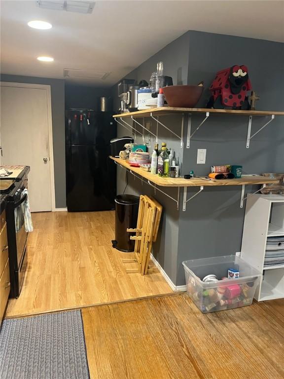 66 Redfish Dr, Rockport, TX 78382 - bar featuring range with gas cooktop, freestanding refrigerator, and light wood-style flooring