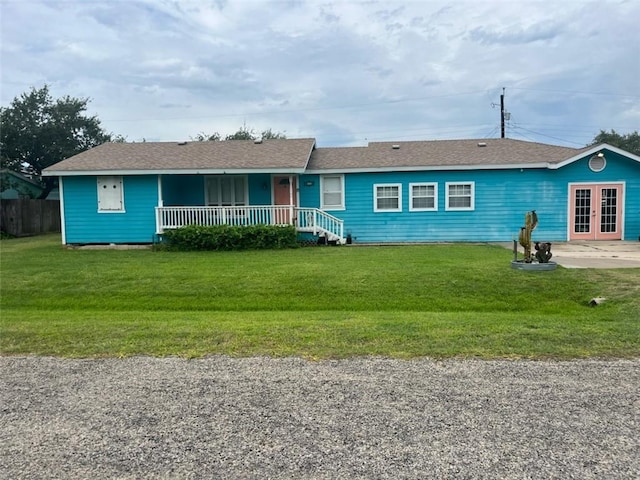 66 Redfish Dr, Rockport, TX 78382 - ranch-style home with a front yard, french doors, and covered porch