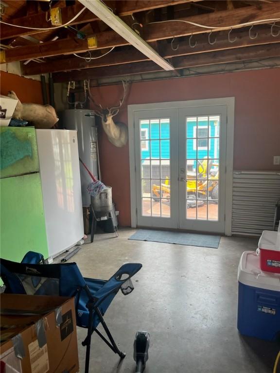 66 Redfish Dr, Rockport, TX 78382 - below grade area featuring french doors, water heater, and fridge