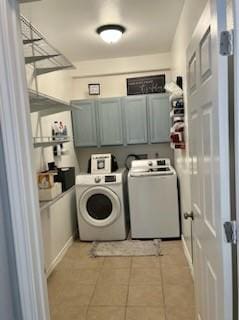 861 Redwood Ave, Rockport, TX 78382 - clothes washing area with cabinet space, washing machine and clothes dryer, and light tile patterned flooring
