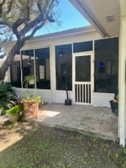 rear view of house featuring a sunroom